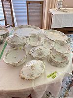 overview of approximately ten Theodore Haviland Limoges serving pieces on table