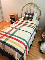 Twin bed showing brass headboard and assembled frame