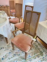 Front view of armchair and side chairs around dining table