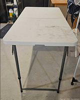 Top view of folded-top rectangular table showing overall condition and surface marks