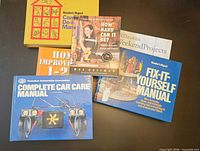 Group of six DIY and repair books fanned out