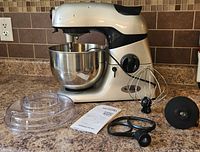 Stand mixer with bowl and all accessories laid out
