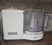 Side view of assembled Braun food processor showing base, bowl and lid