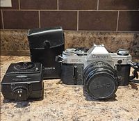 Camera, flash, case grouped together