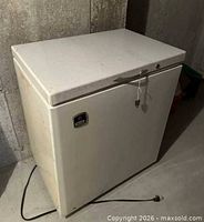 Front and top view of chest freezer showing latch and power cord