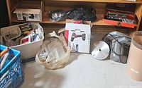 Overview shelf with drill box, bins, blades, goggles