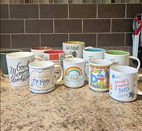 Group shot of all 11 mugs on countertop