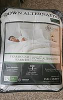 Front of packaged down alternative queen comforter, showing branding and specifications