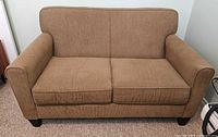 Front view of love seat showing cushions and fabric