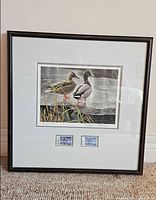 Full view of framed Robert Bateman print with stamps