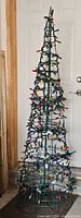 Full view of metal frame Christmas tree with lights