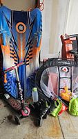 All items grouped: sled, scooter, skates, net, bottle, shovels