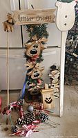 Overall view showing Reindeer Crossing stake, pinecone picks, lantern and snowman stake