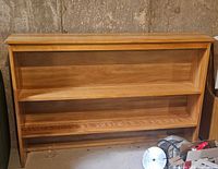Front view of pine bookcase showing shelves and overall condition