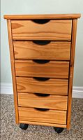 Front view showing six drawers and casters