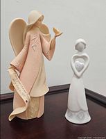 Both angel figurines displayed side by side