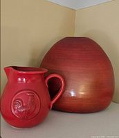 Front view of both red decor items, showing size and finish