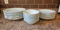 Stacked dinner plates, bread plates, bowls showing counts and colour