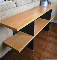 Full view of console shelving unit against sofa