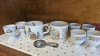 Group shot showing mugs, egg cups, spoon