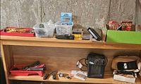 Overall view of shelving with heater, hardware bins, tool belt, tray of tools