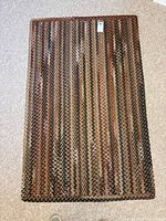 Full view of rectangular braided rug on floor