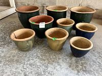 Eight assorted ceramic planters grouped on floor