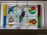 Full view of stained glass panel showing all motifs and colours