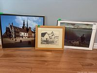 All three framed artworks standing on floor for scale and overview
