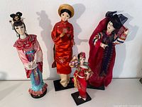 Group shot of all four vintage Asian dolls on stands