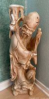 Front view of Shou Lao plaster statue showing overall form and damage