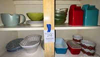 Cabinet shelves displaying majority of dishware items