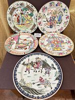 Front view of all five decorative plates showing designs
