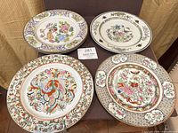 Four of the decorative Asian plates overall