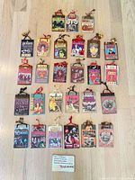 Group shot of all 27 handmade rock ‘n’ roll wood plaques laid out on floor