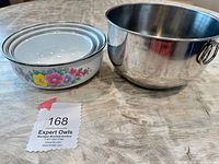 Stacked enamel nesting bowls beside stainless bowl
