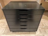 Front view of black 6-drawer cabinet showing drawer fronts and overall condition