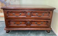 Front view of Drexel two-drawer chest showing hardware, finish, bun feet