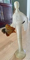 Front view showing full figurine details and butterfly accent