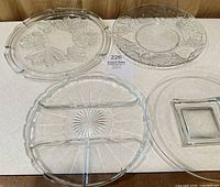 Group shot showing all four glass trays with varied designs and shapes