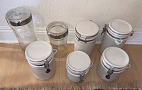 Group shot of all eight canisters showing size and material differences