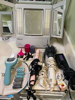 Entire lot laid out on vanity showing mirror, hair tools, foot file, rollers and clips