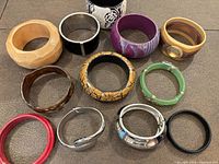 Group shot showing all thirteen bracelets and cuffs