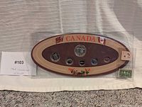 Front view of complete coin set and stamps in packaging