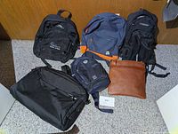 Six assorted bags arranged on floor