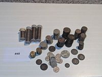 Overview of stacked and loose coins with plastic tubes