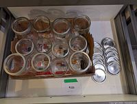 Top view showing 12 jars with lids and extra rings