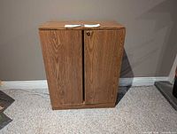 Front view of wood veneer cabinet with two doors and lock