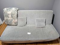 Futon in upright position with cushions visible
