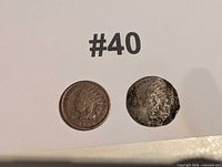 Two Indian Head pennies side by side on numbered background